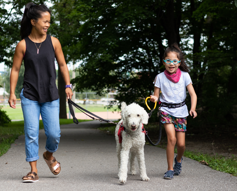 Mother with child tethered to her Autism Assistance Dog