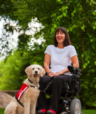 Woman in a  wheelchair with her Service Dog Guide