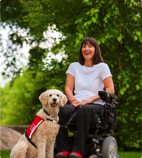 Woman in a  wheelchair with her Service Dog Guide