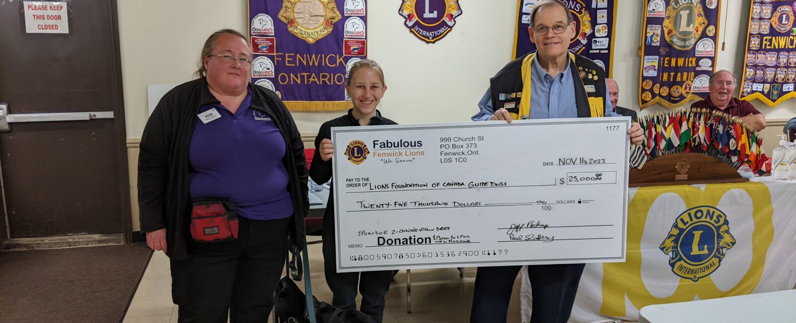 Lions club hand over cheque to Dog Guides' staff