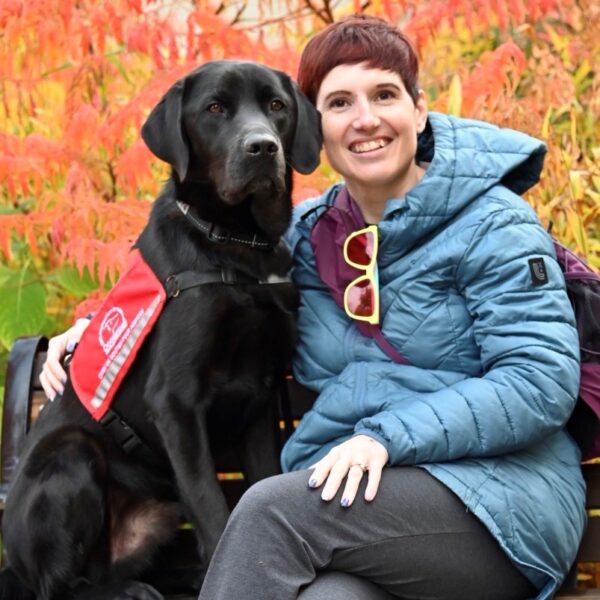 Woman next to Facility Support dog