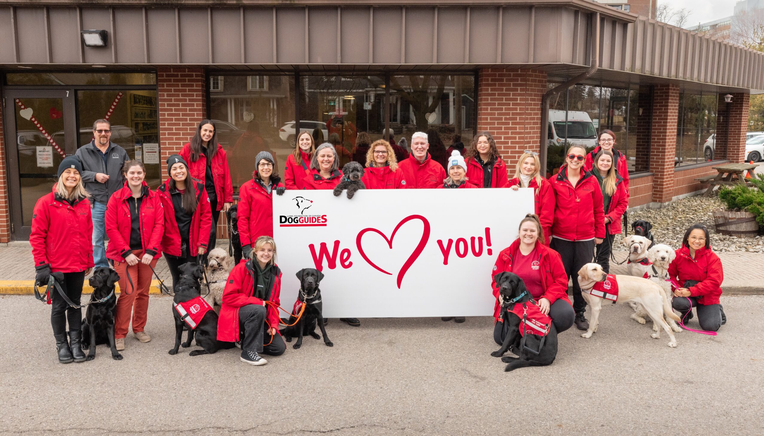 Be-Kind 2 LFCDG staff hold a sign that says "We heart you"